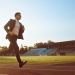 Guy Running On Racetrack In Business Suit