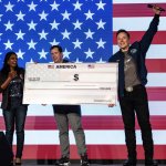 Elon Musk holding giant America check