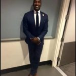 black guy in suit shy