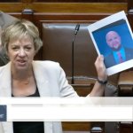 Politician holding up picture of JD Vance