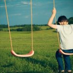 Sad kid on swing