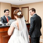 Bride and groom checking into a hotel template