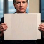 Gavin Newsom with sign