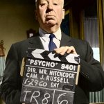 Hitchcock holding Psycho sign