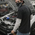 White-Sleeved Alexander Tuning A Car