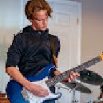 August playing guitar