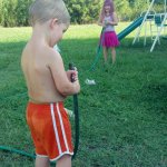 Children playing with a garden hose
