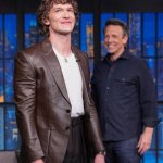Seth Meyers smiling at Connor Storrie