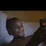 man looking at phone smiling