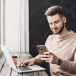 guy on phone and laptop at the same time