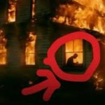 Man writing in burning house