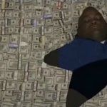 Huell Babineaux laying on a pile of money
