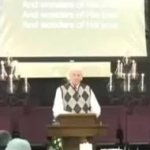 Church candles crash behind preacher pastor