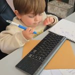 child baby genius computer keyboard work pen writing