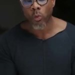 Black guy with glasses eating a green apple GIF Template