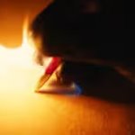 Pen on fire writing on paper