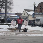 Clown holds a sign