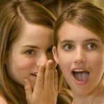 two girls whispering