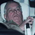 Andrew cowers in car