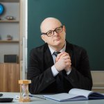 wise elderly man teacher professor desk classroom
