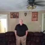 Guy standing next to fan