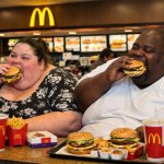 Fat black and white people eating McDonald's
