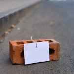 Message note tied to brick