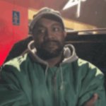 Kanye crossing his arms