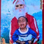 Creepy Santa holding a crying child
