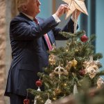 Donald Trump puts the star on the Christmas tree