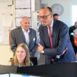 Friedrich Merz looking at a computer