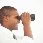 man looking through lunette smiling