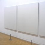 Man staring at empty paintings