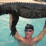 Florida man holding alligator