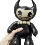 Hand holding Heavenly Toys's Bendy Plushie