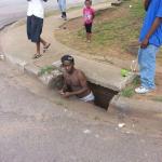 man coming out of sewer 