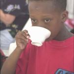Mad Black kid sips tea