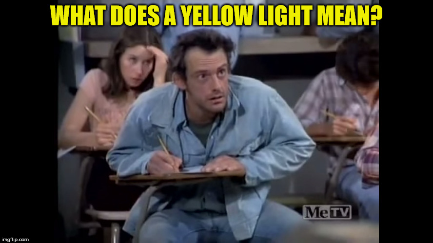 Ignatowski is taking his driving test | WHAT DOES A YELLOW LIGHT MEAN? | image tagged in iggy,jim ignatowski,taxi,louie depalma,elaine nardo,memes | made w/ Imgflip meme maker