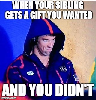 Michael Phelps Death Stare | WHEN YOUR SIBLING GETS A GIFT YOU WANTED; AND YOU DIDN'T | image tagged in memes,michael phelps death stare | made w/ Imgflip meme maker