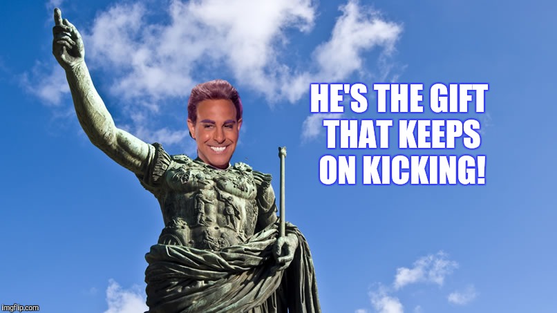 Hunger Games - Caesar Flickerman (S Tucci) Statue of Caesar | HE'S THE GIFT THAT KEEPS ON KICKING! | image tagged in hunger games - caesar flickerman s tucci statue of caesar | made w/ Imgflip meme maker