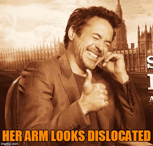 laughing | HER ARM LOOKS DISLOCATED | image tagged in laughing | made w/ Imgflip meme maker