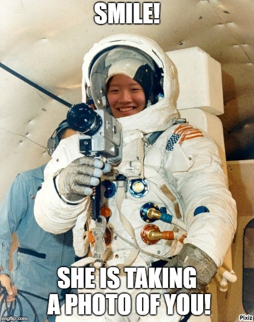 Astronaut Phoebe Taking A Photo | SMILE! SHE IS TAKING A PHOTO OF YOU! | image tagged in astronaut,girl,smile,camera | made w/ Imgflip meme maker