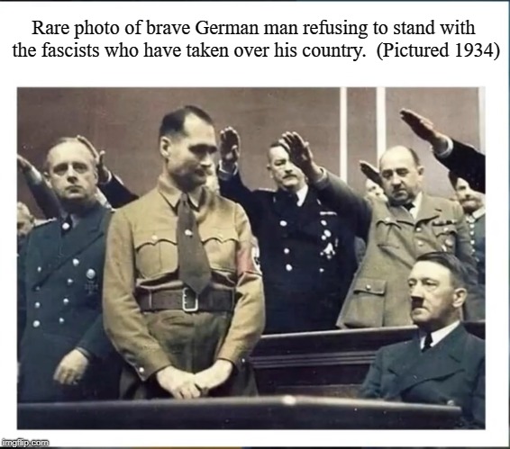 (Pictured 1934) | Rare photo of brave German man refusing to stand with the fascists who have taken over his country.  (Pictured 1934) | image tagged in hilter sitting,history | made w/ Imgflip meme maker