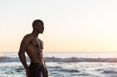 Black man on beach shirtless Blank Meme Template