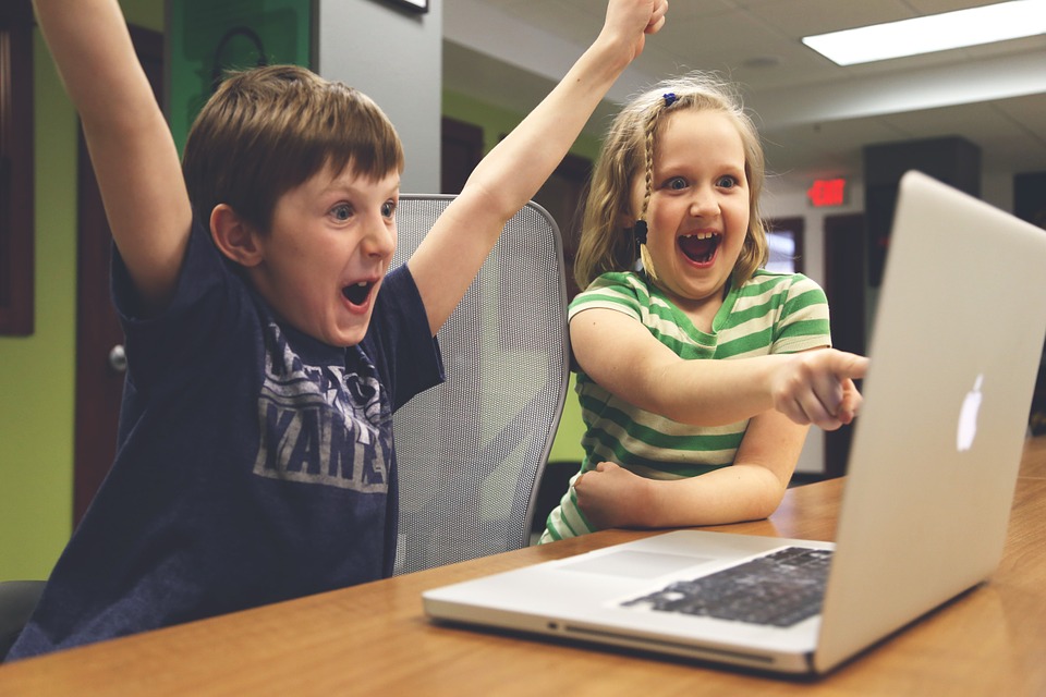Excited happy kids pointing at computer monitor Blank Meme Template