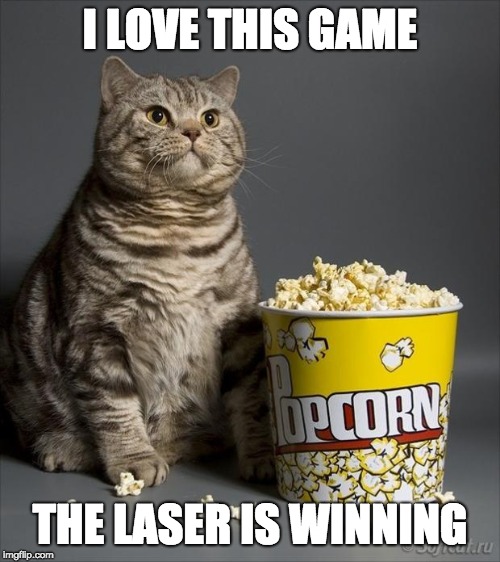 Cat eating popcorn | I LOVE THIS GAME; THE LASER IS WINNING | image tagged in cat eating popcorn | made w/ Imgflip meme maker