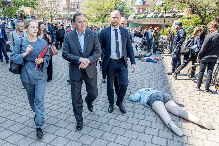High Quality Swedish prime minister walking by climate protesters Blank Meme Template