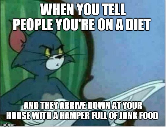 Interrupting Tom's Read | WHEN YOU TELL PEOPLE YOU'RE ON A DIET; AND THEY ARRIVE DOWN AT YOUR HOUSE WITH A HAMPER FULL OF JUNK FOOD | image tagged in interrupting tom's read,am i a joke to you,healthy living,cutting out the carbs | made w/ Imgflip meme maker