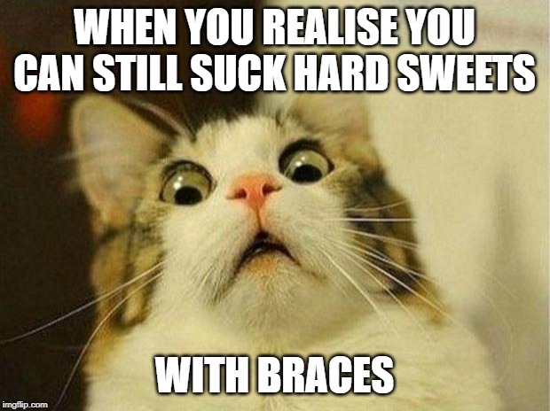 Scared Cat | WHEN YOU REALISE YOU CAN STILL SUCK HARD SWEETS; WITH BRACES | image tagged in memes,scared cat | made w/ Imgflip meme maker