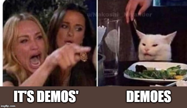 Cat at table | IT'S DEMOS'                   DEMOES | image tagged in cat at table | made w/ Imgflip meme maker